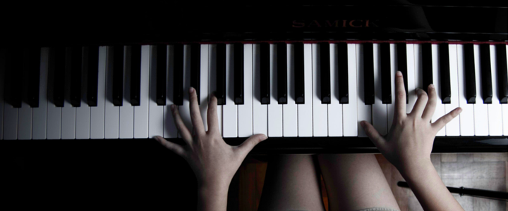 Hands on the piano keys during a music lesson