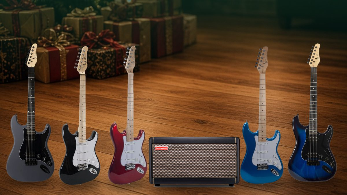 Jay Turser electric guitars in matte grey, black, metallic red, metallic blue and transparent blue with a Positive Grid Spark 40 amp, in front of holiday gifts